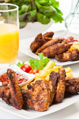 Chicken wings with fries french and spicy sauce