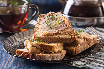 Slices of bread with baked pate on plate