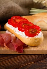 Fresh baguete with cottage cheese and tomato slices