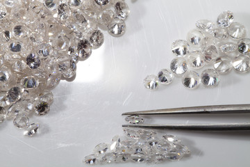 Selected  round  and Marquise diamond shape with tweezers.