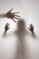 shadow of a girl behind transparent paper