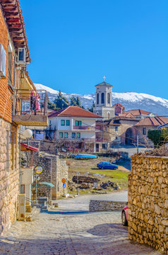 :view of the belltower of Church St. Bogorodica Perivlepta through old style street with traditional houes in ohrid, macedonia, fyrom.