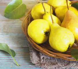 Wicker basket of ripe pears, close up
