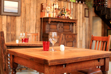 Interior of the cafe, tables, chairs and a wooden wall