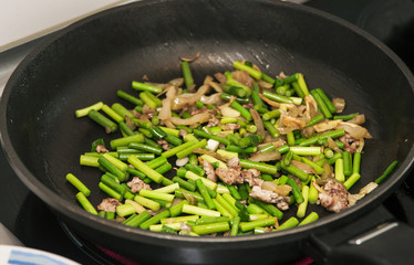 Stir frying green vegetables with ground beef