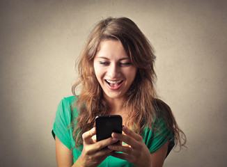 Happy woman looking at her phone