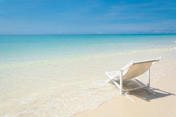 Fototapeta na wymiar beach chair on beach with blue sky
