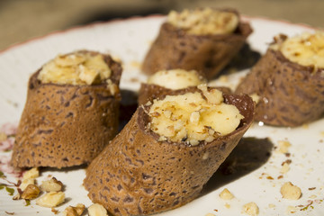 Delicious pieces of  pancakes with honey syrup, nuts and  filled with banana