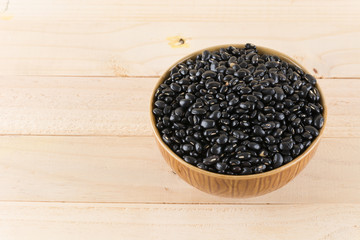 black beans on wood background