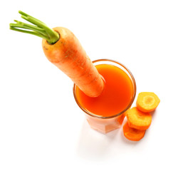 Glass of carrot juice with vegetable slices with vegetables isolated on white