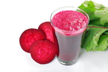 Glass of beet juice with vegetables isolated on white