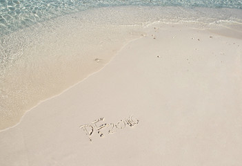 Handwriting inscription 2016 on the beach