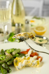 Roasted asparagus with fried egg on plate on table background