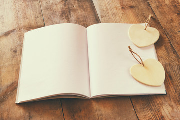 open blank notebook over wooden table. ready for mockup. retro filtered image
