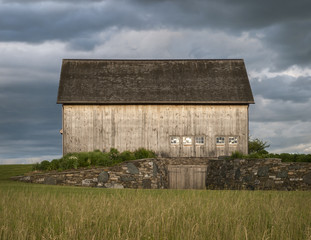 Wooden Barn on Hilltop Before A Storm