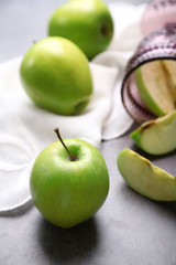 Green apples on wooden table with napkin, closeup