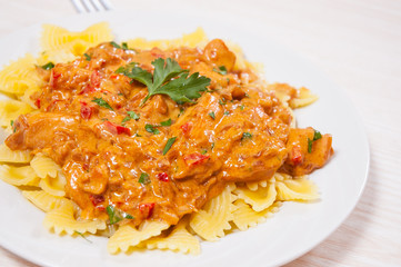 meat in a sauce with farfalle pasta