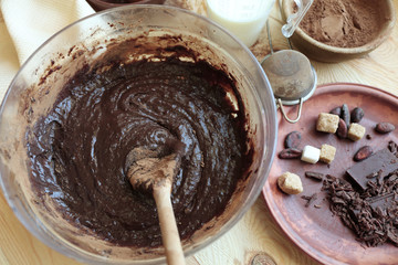 Preparing dough for chocolate pie on table close up