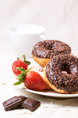 Chocolate donuts with fresh strawberries