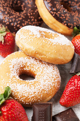 Chocolate donuts with fresh strawberries