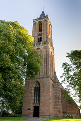 Church tower in Amerongen (Netherlands) against blue sky in summer.