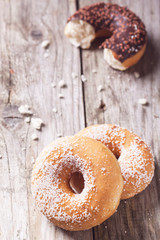 Donuts over wooden background