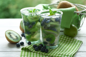 Kiwi and Blueberry cocktails on wooden background