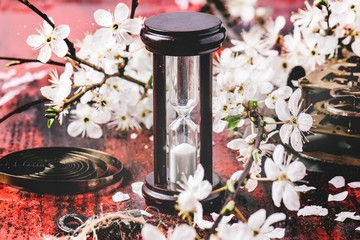 Vintage hourglass with blossom branch
