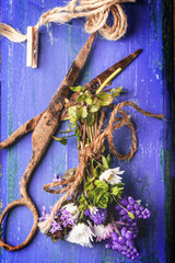 Bouquet of wildflowers and old rusty scissors