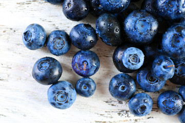 Tasty ripe blueberries on wooden table close up