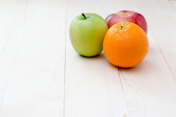 Apple and orange fruit on wooden background