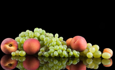 White grapes on a black background with peaches
