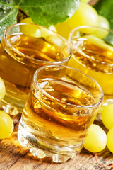 Light grape juice on wooden  background, selective focus