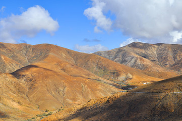Fototapeta na wymiar Beautiful volcanic mountains and blue sky. Fuerteventura