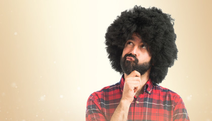 Afro man thinking over white background