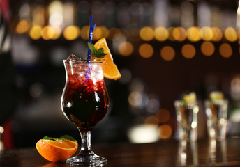Cocktail on bar counter on bar background