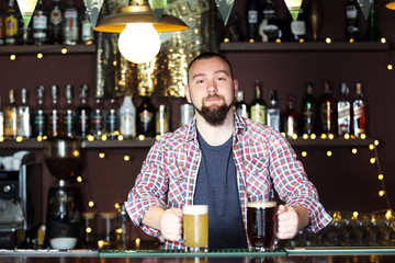 Portrait of handsome bartender at workplace
