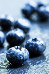 Fresh ripe blueberries on a dark background, selective focus