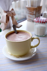 Mug of hot cocoa on table in cafe