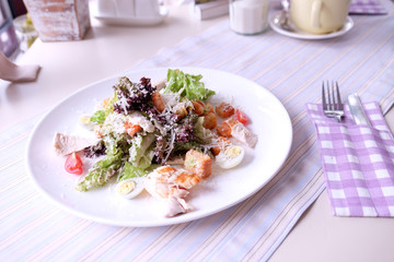 Caesar salad on table in cafe