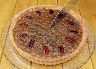 Starting to slice a pecan pie