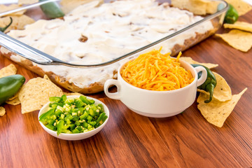 preparation of bean dip with jalapenos, sour cream and cheddar c