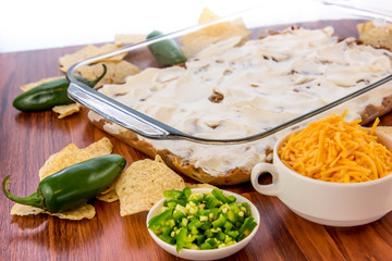 preparation of bean dip with jalapenos, sour cream and cheddar c