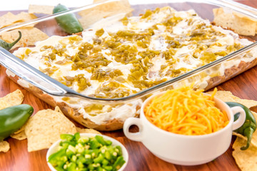 preparation of bean dip with jalapenos, sour cream and cheddar c