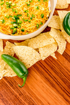preparation of bean dip with jalapenos, sour cream and cheddar c