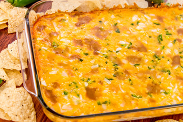 hot bean dip with jalapenos, sour cream and melted cheddar chees