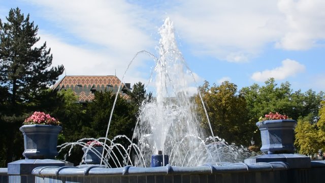 Footage of running water from all hoses of city fountain in Subotica, Serbia. Filmed on sunny day, about noon. In the background are blue clouds.
