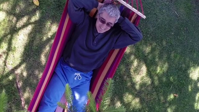 Man With Comical Expression Relaxing In Hammock