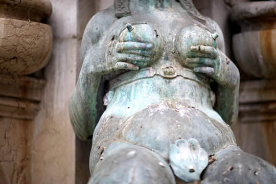 Breast pumping, the Neptune fountain, Bologna, Italy