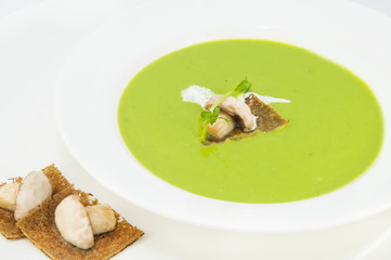 pea soup on a white dish at restaurant